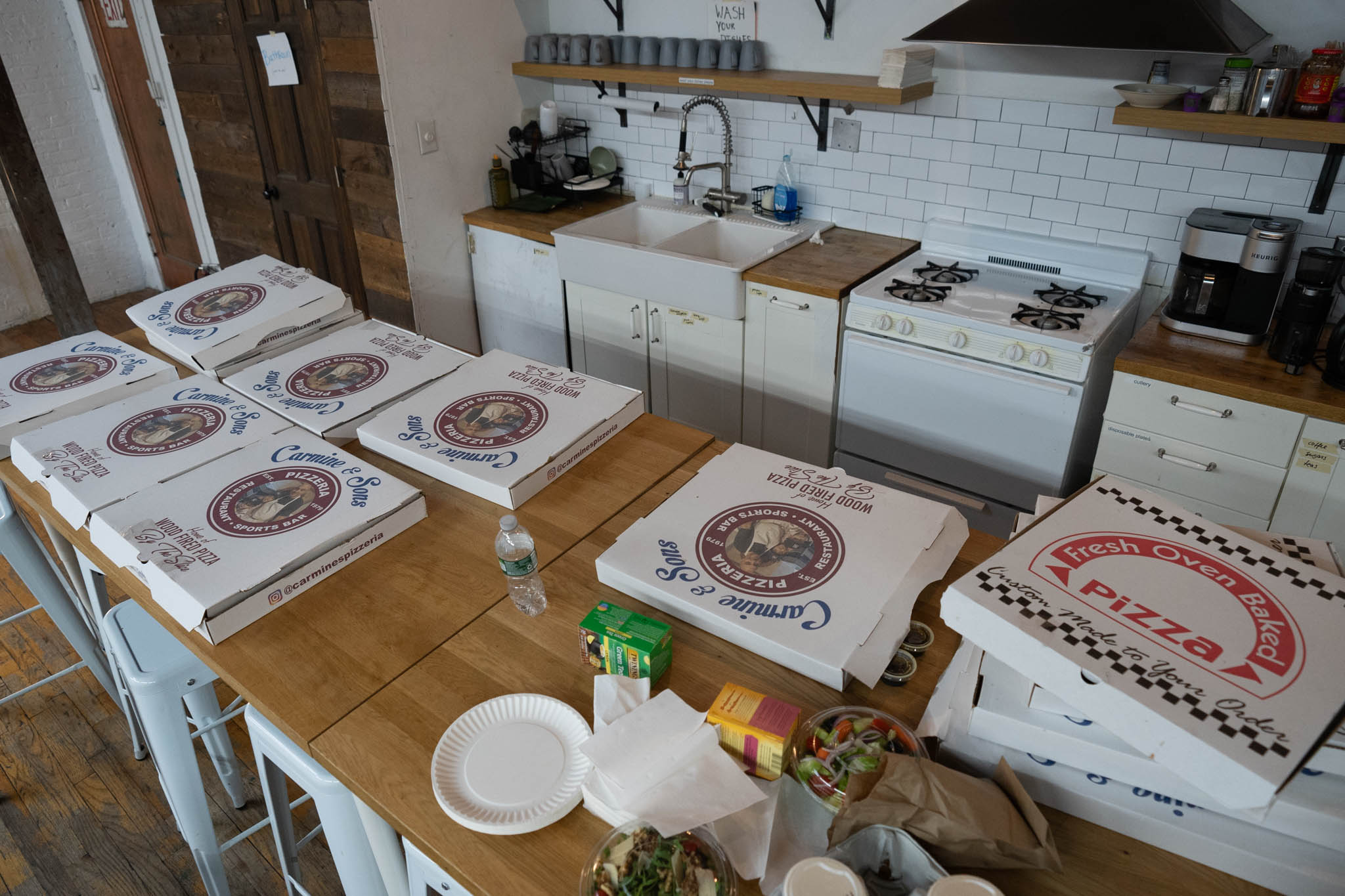 Table covered in pizza boxes